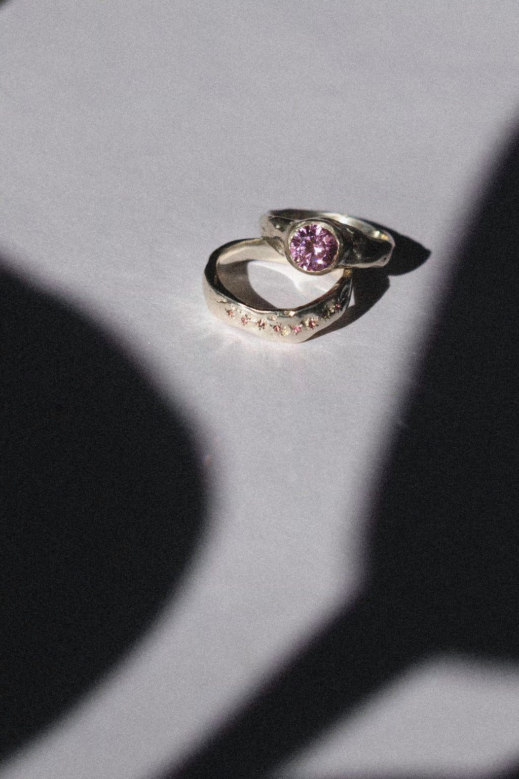 silver and pink cubic zirconia ceremonial ring set on a white background 