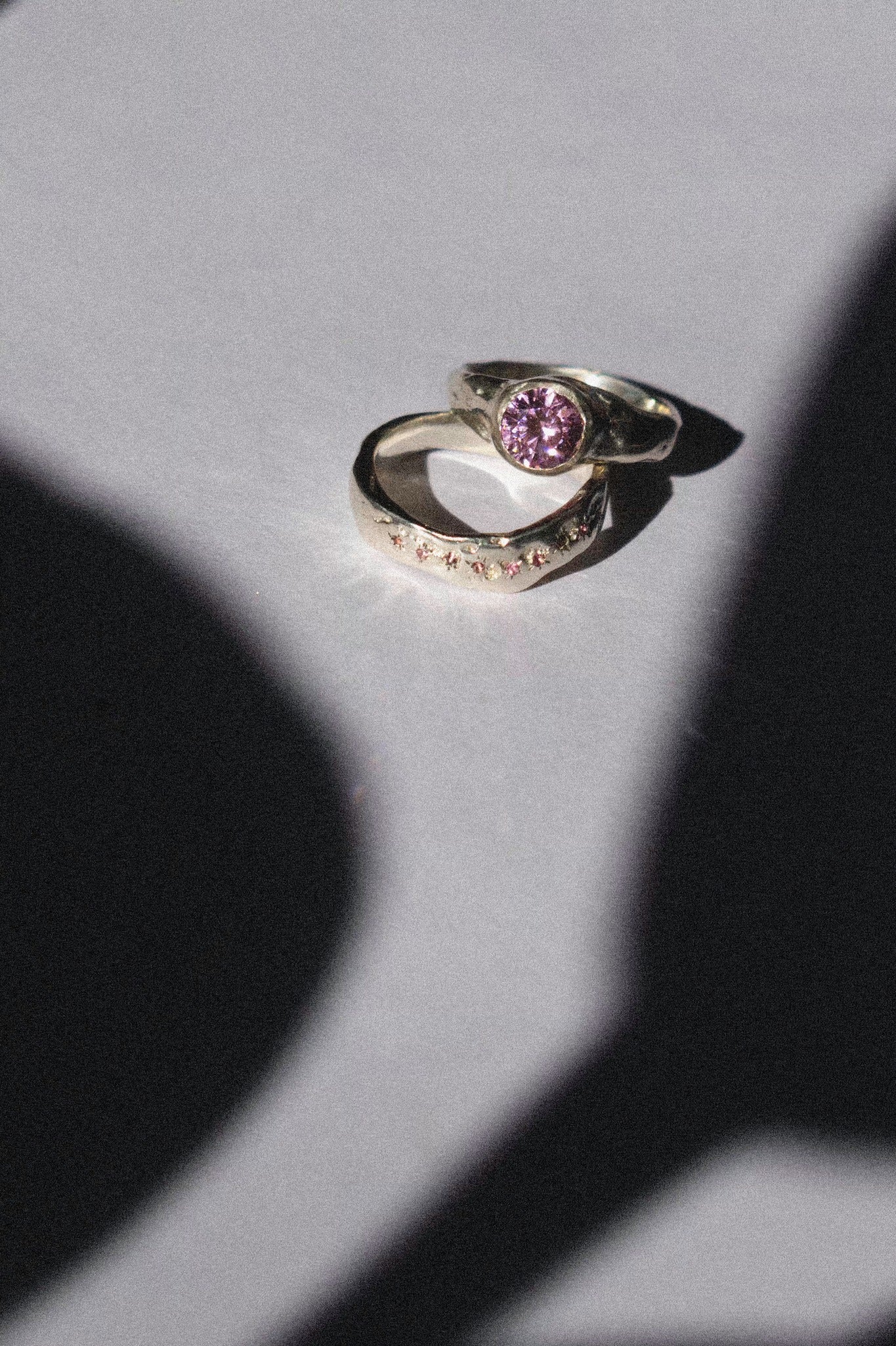 silver and pink cubic zirconia ceremonial ring set on a white background 