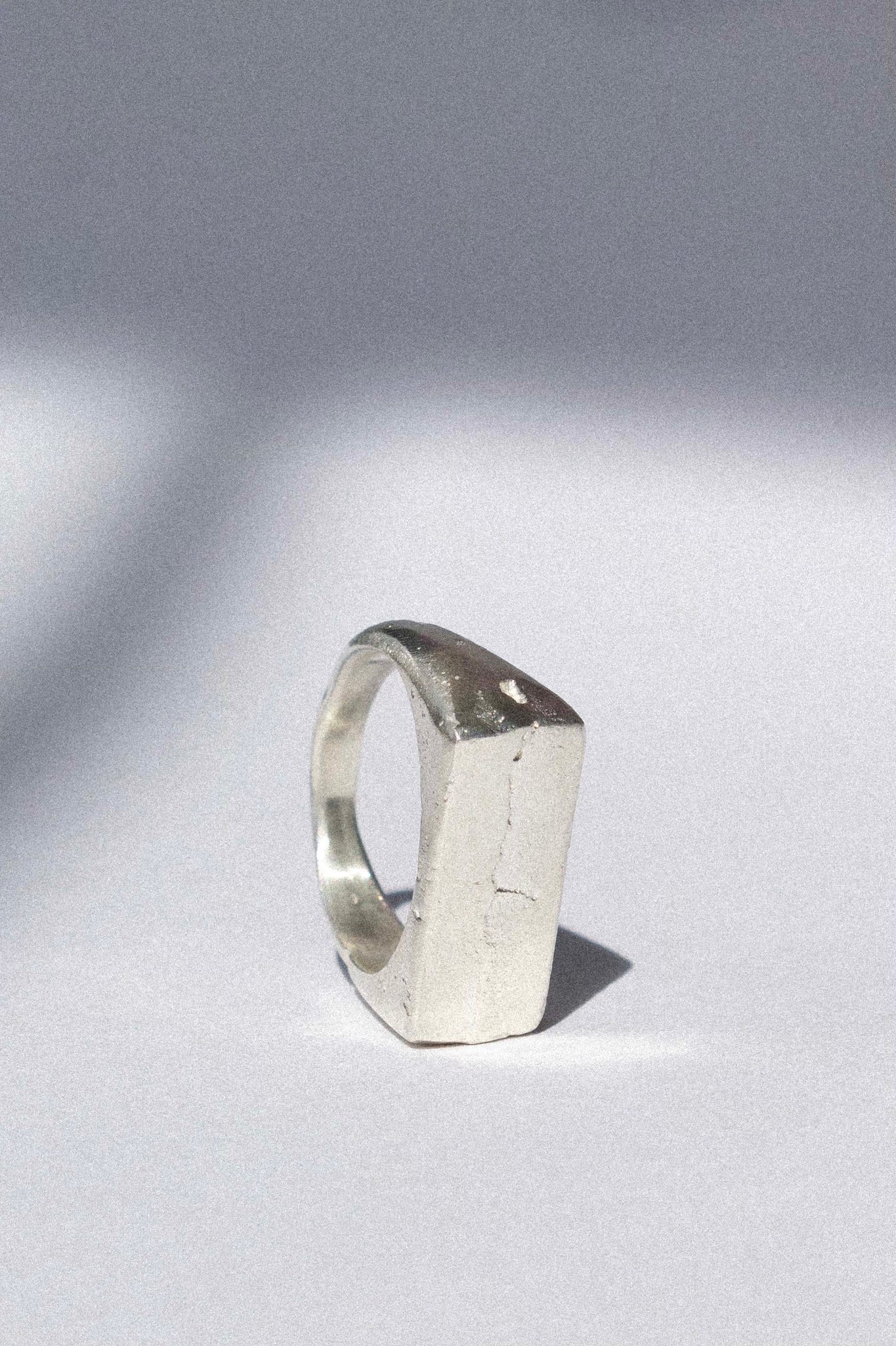 organic silver signet ring on a white background