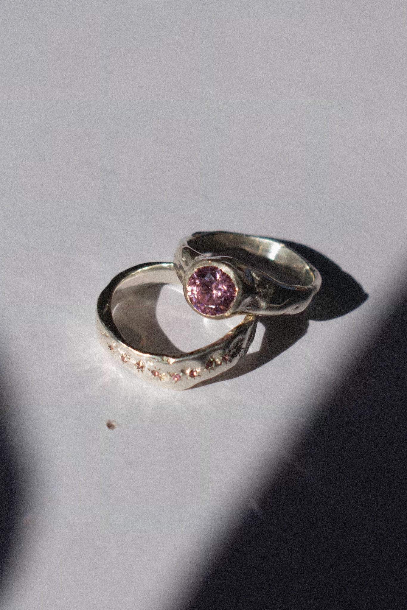 silver and pink cubic zirconia ceremonial ring set on a white background 