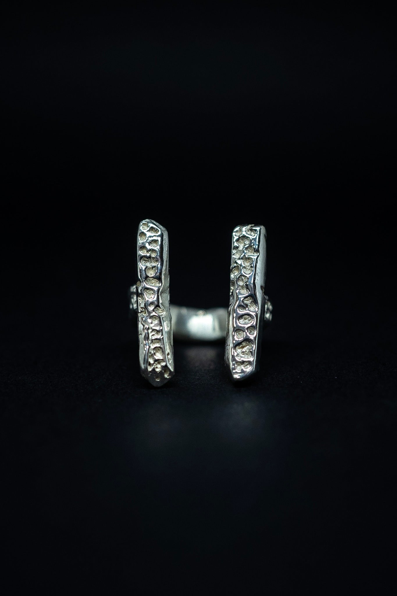 handmade silver ring on a black background