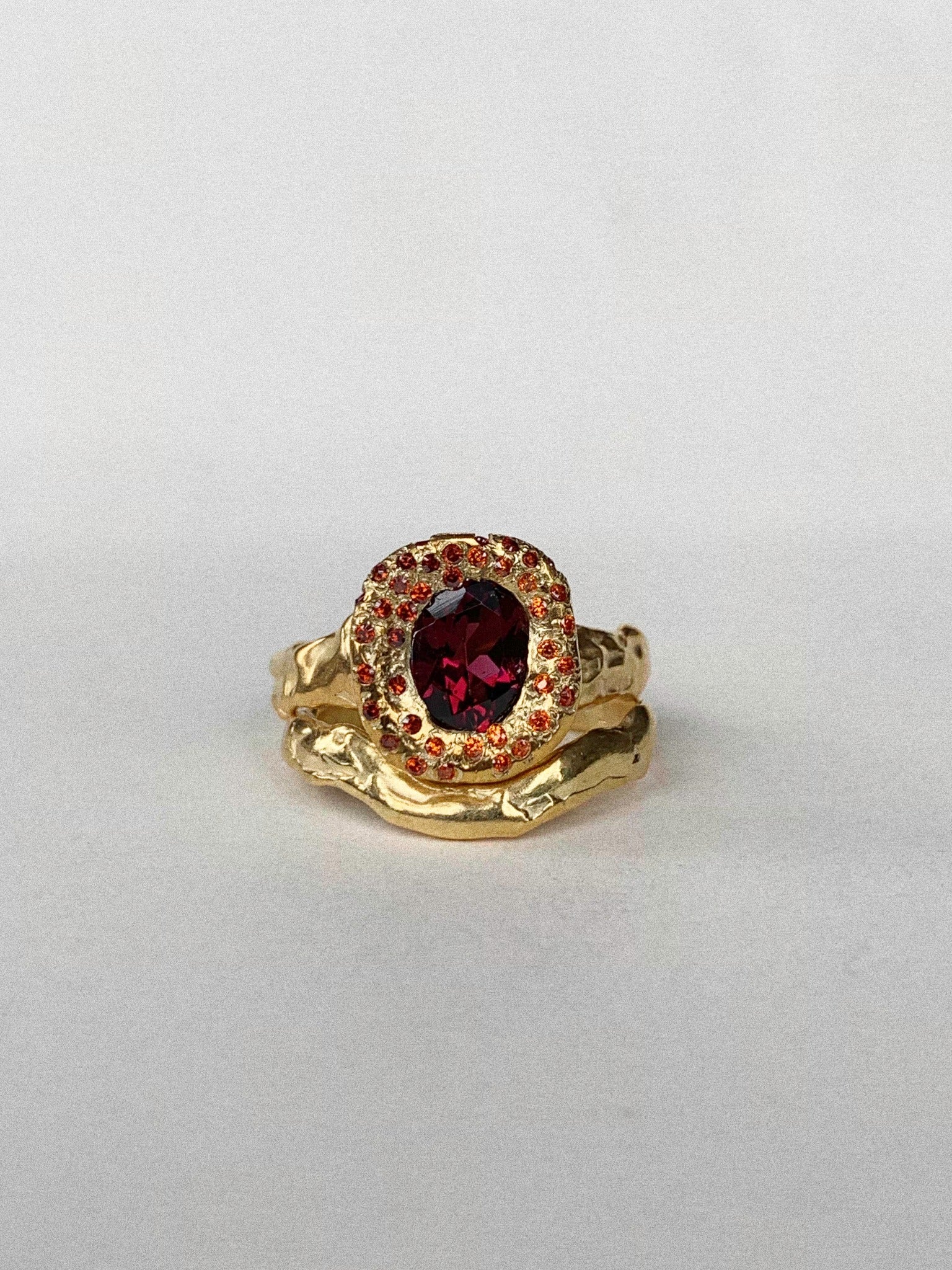 a gold ceremonial set with a large garnet in the centre