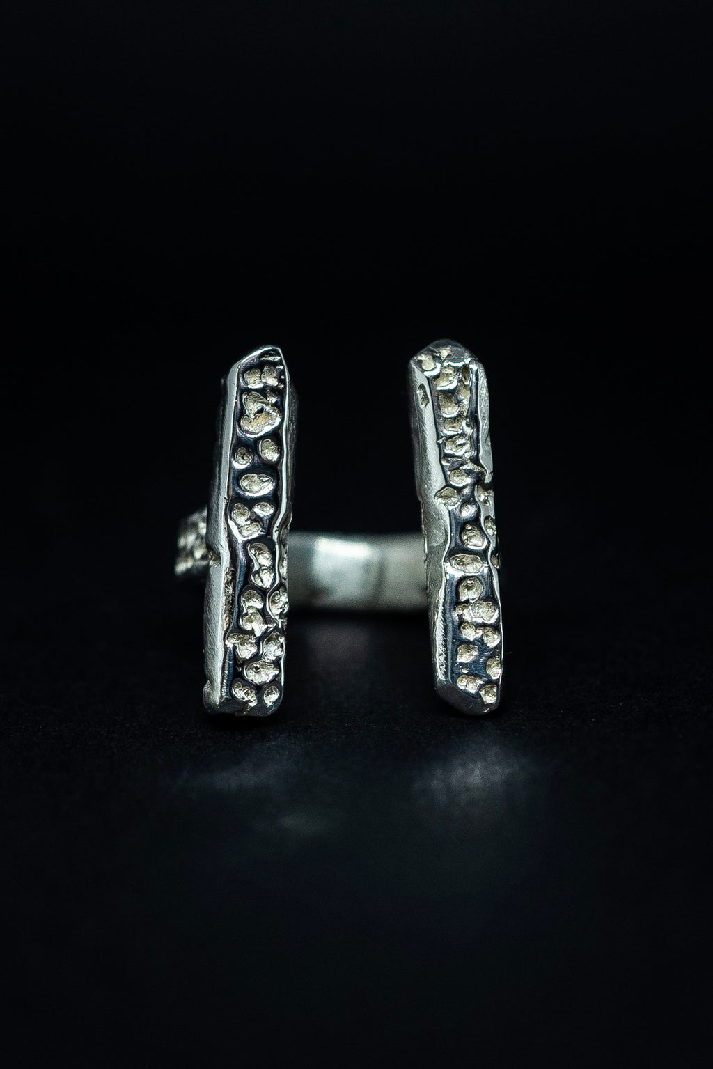 handmade silver ring on a black background