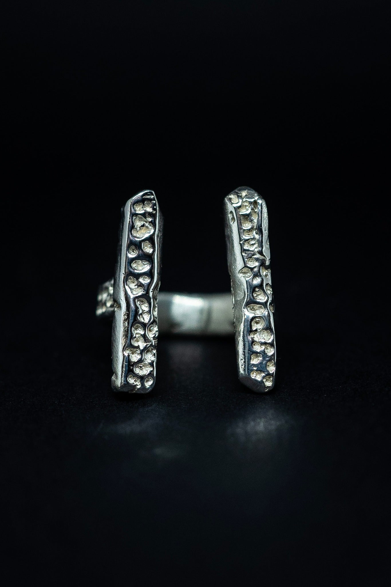 handmade silver ring on a black background