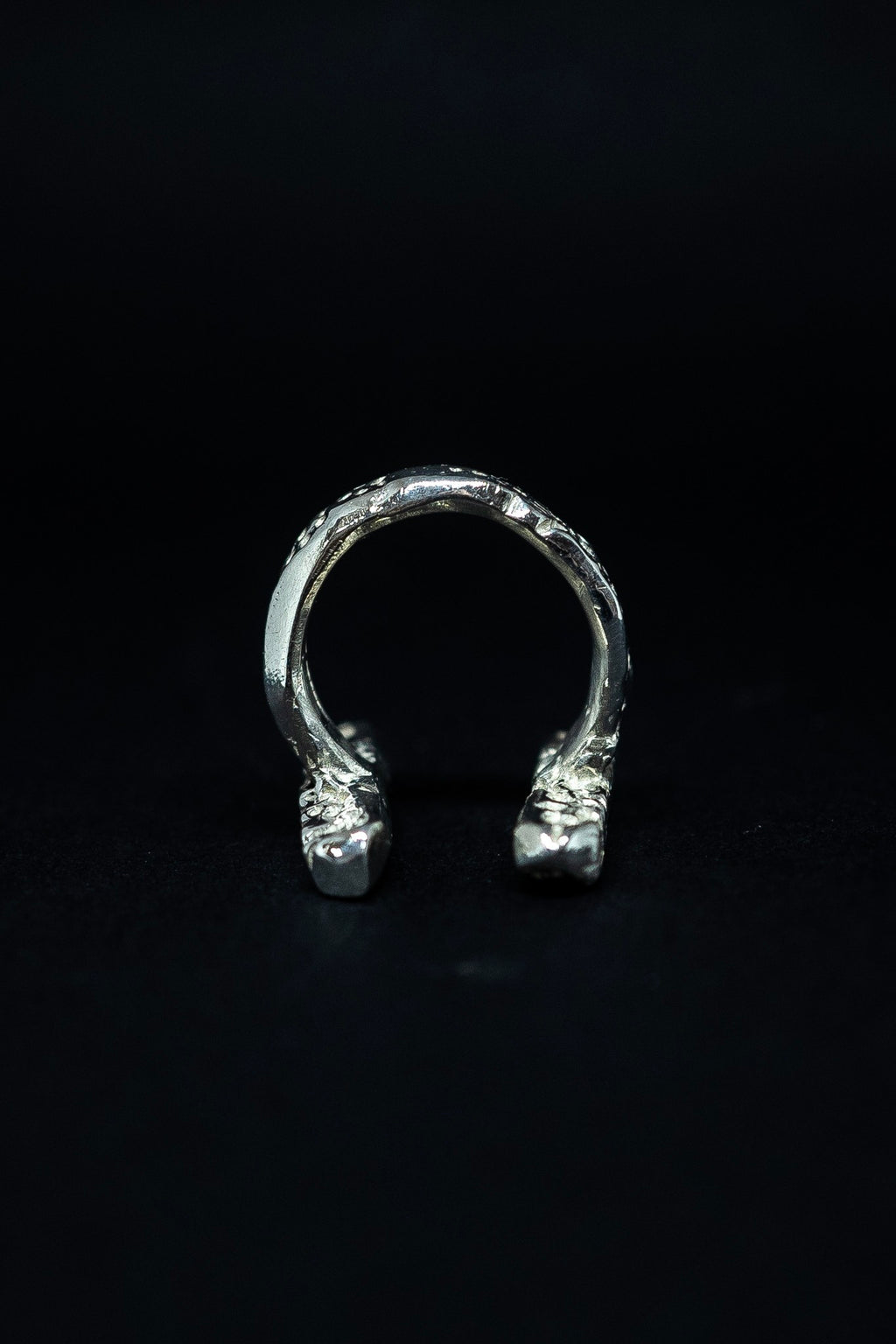 handmade silver ring on a black background