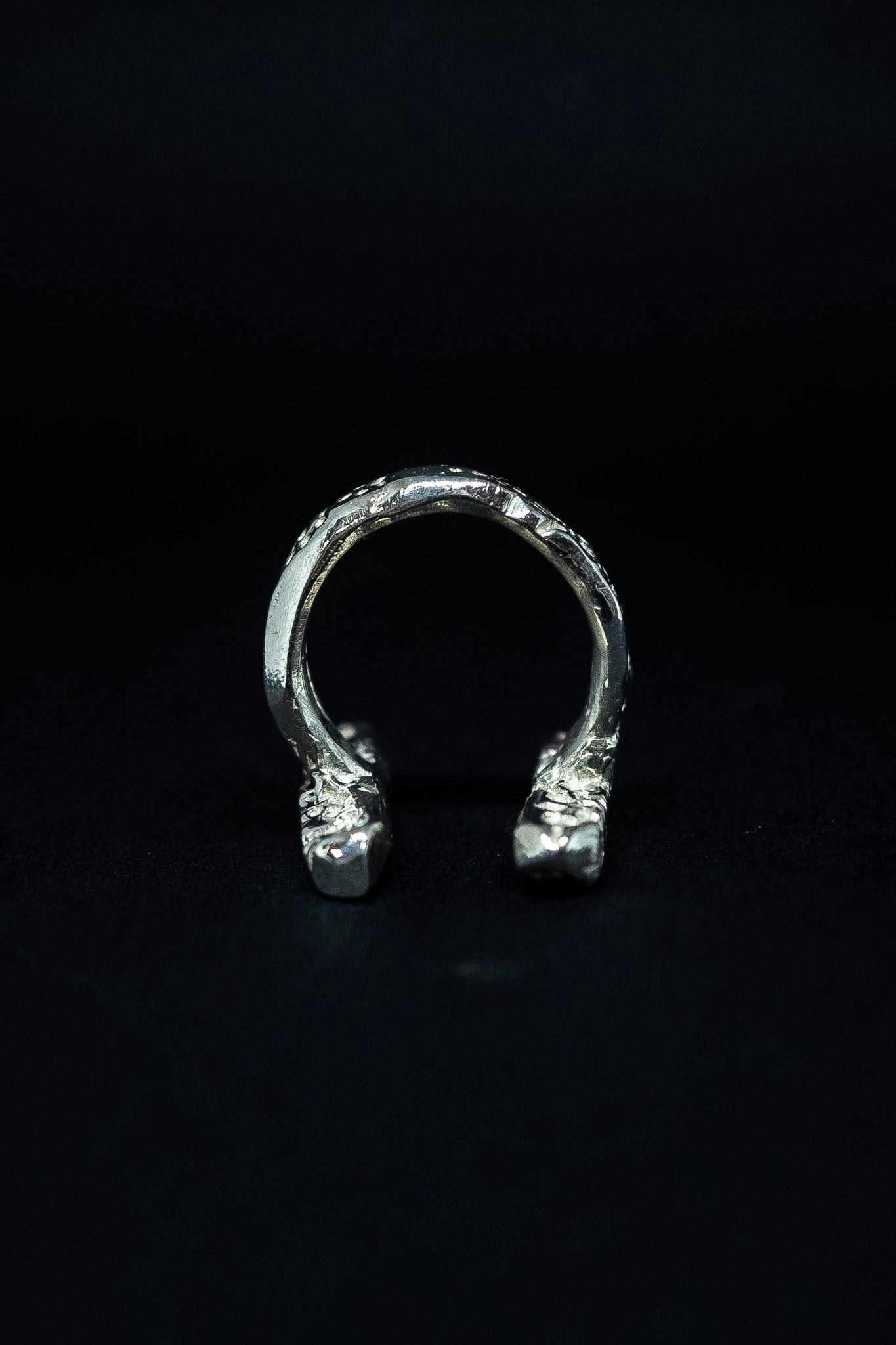 handmade silver ring on a black background