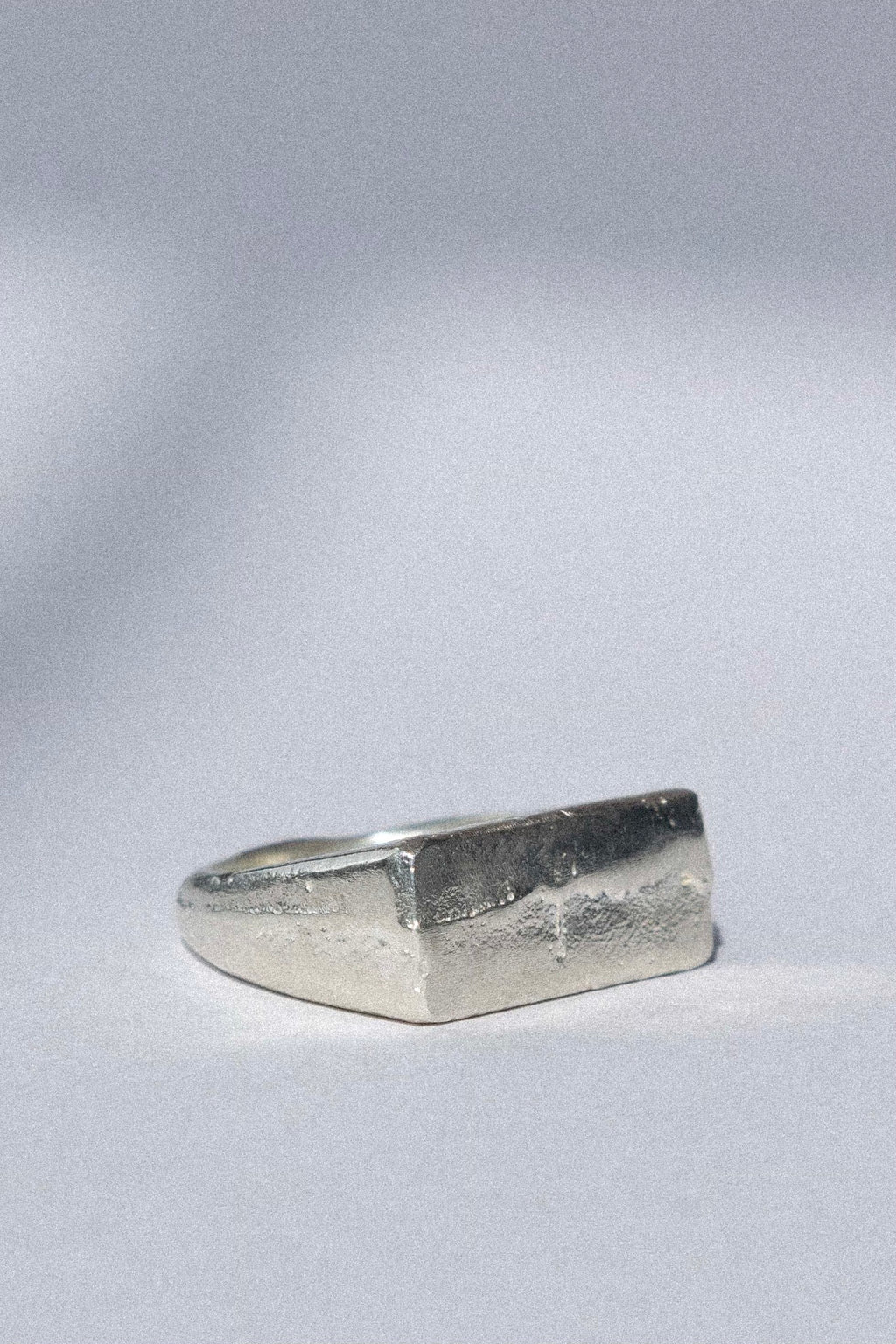 organic silver signet ring on a white background