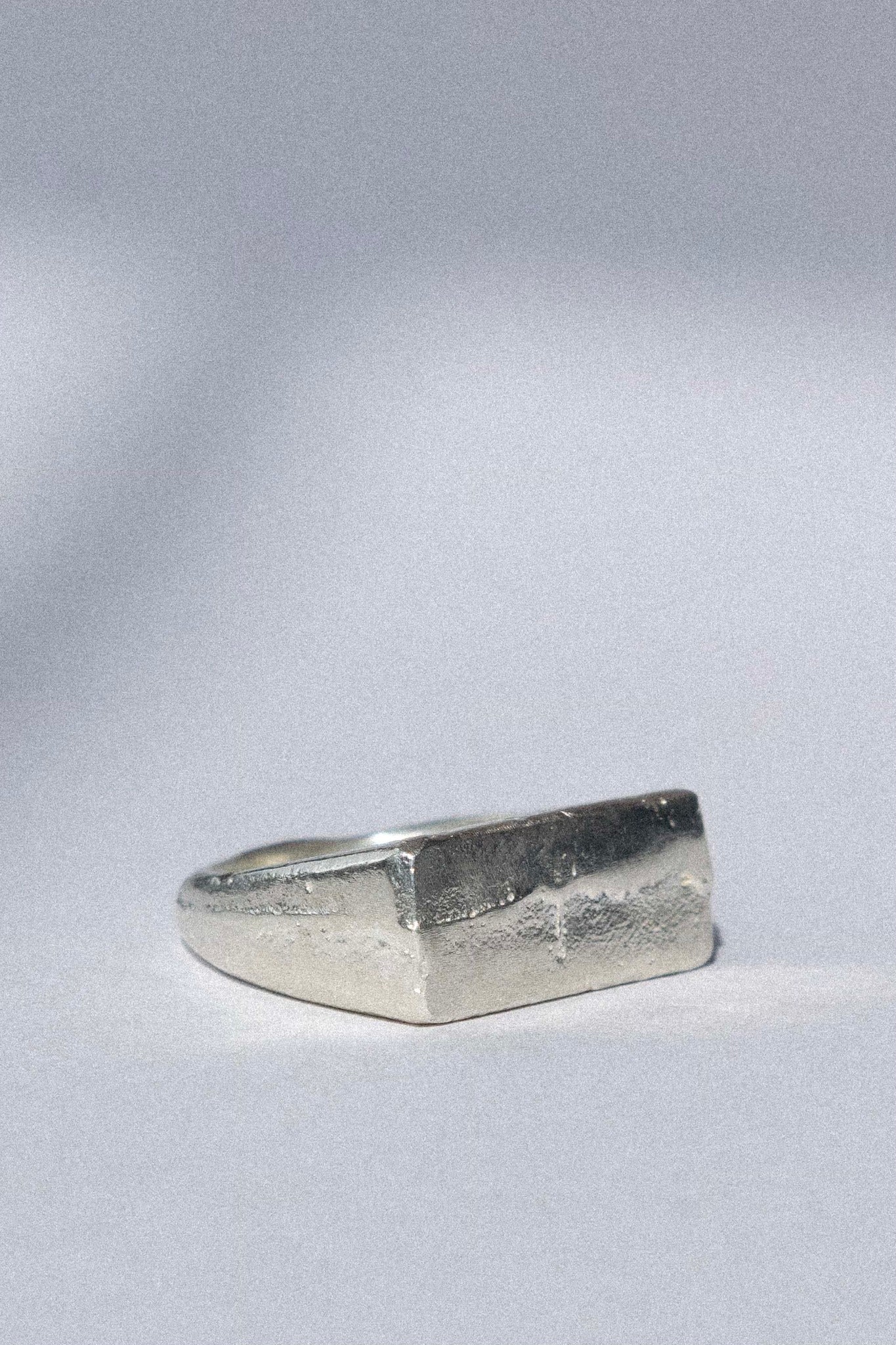 organic silver signet ring on a white background