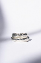 two white gold wedding rings on a white background