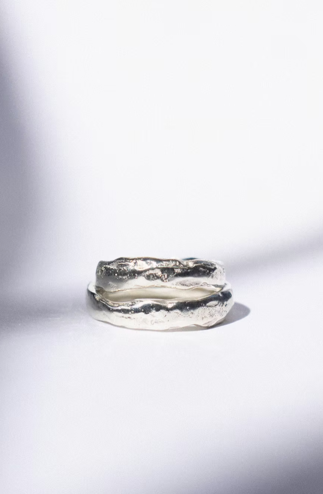 two white gold wedding rings on a white background