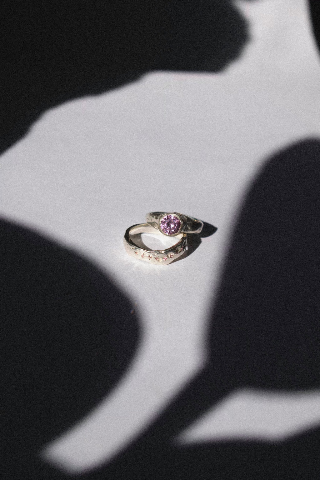 silver and pink cubic zirconia ceremonial ring set on a white background 