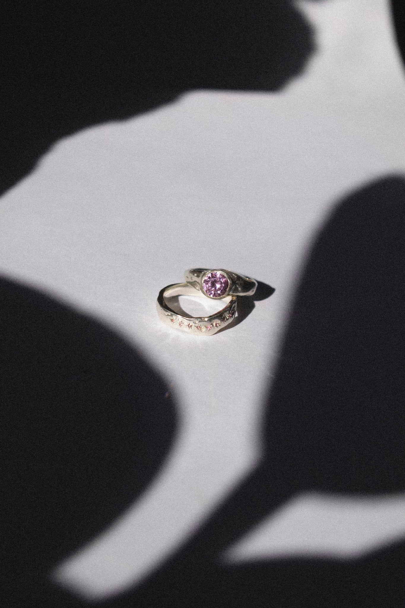 silver and pink cubic zirconia ceremonial ring set on a white background 