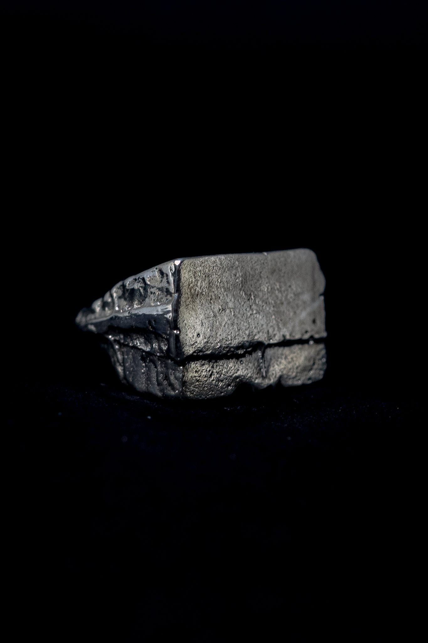 silver raw signet ring on a black background