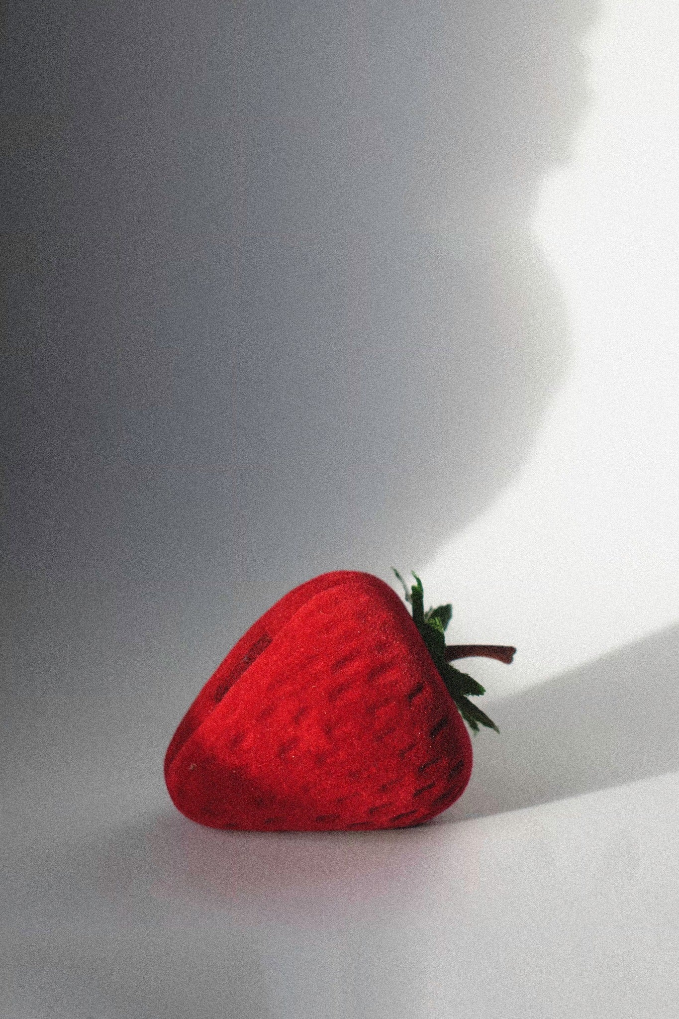 a strawberry ring box on a white background