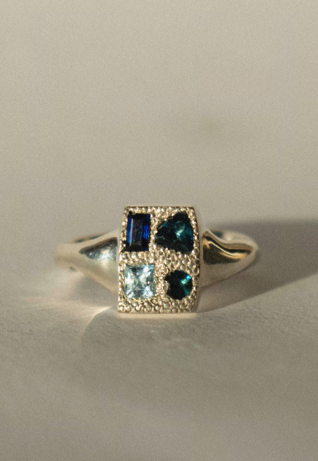 silver signet ring with blue monochromatic gemstones