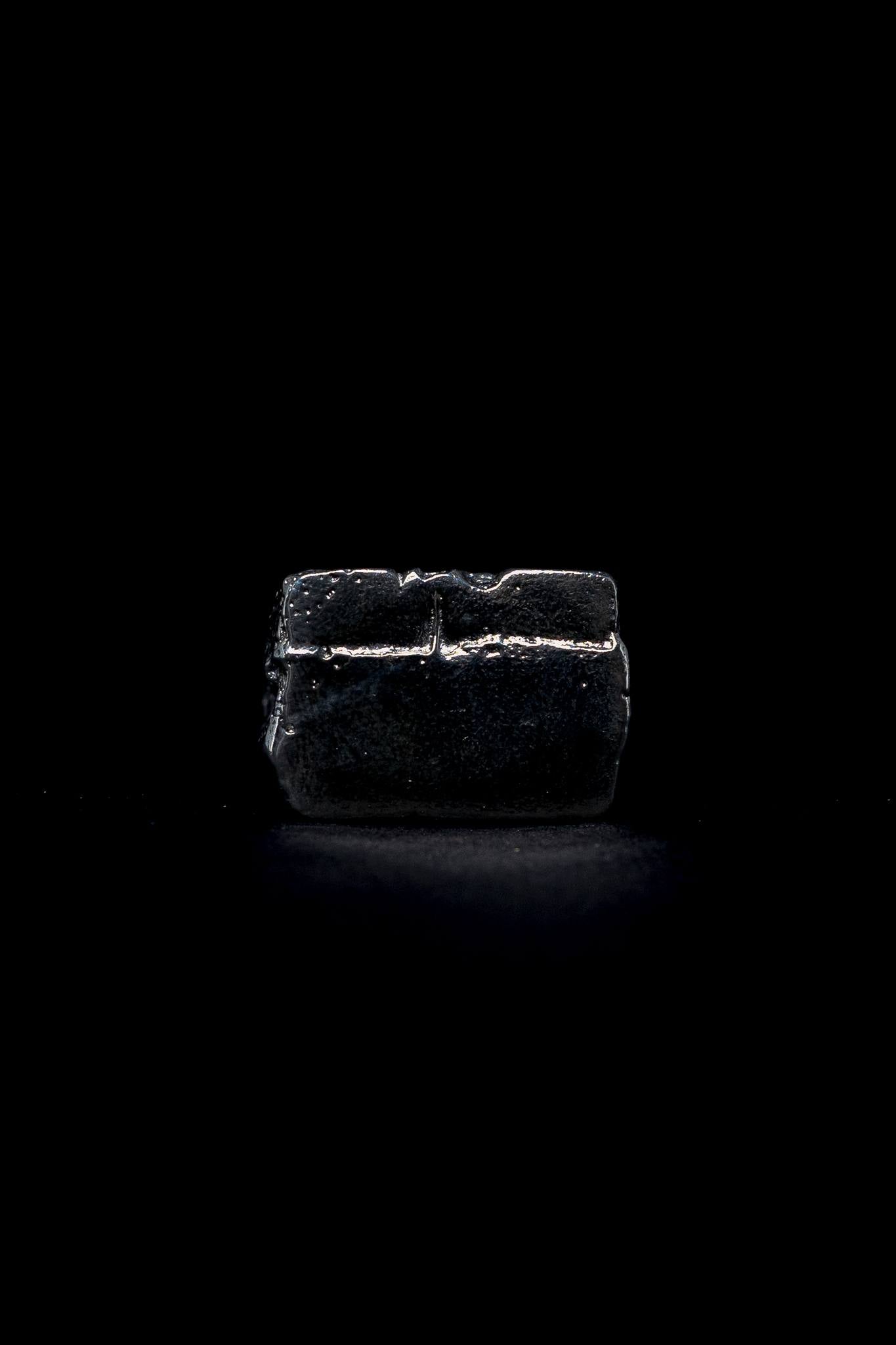 silver raw signet ring on a black background
