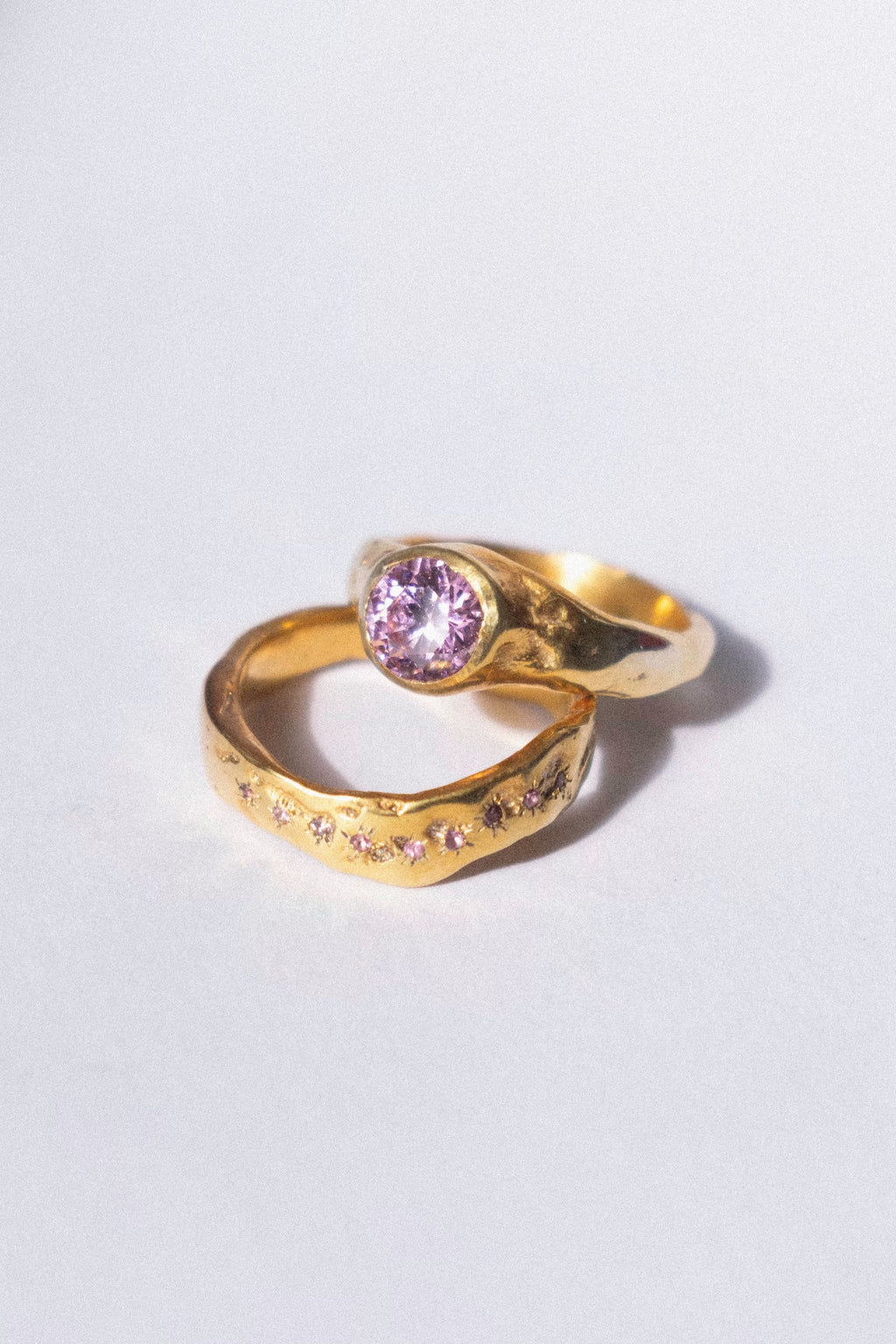 gold and pink diamond ceremonial ring set on a white background