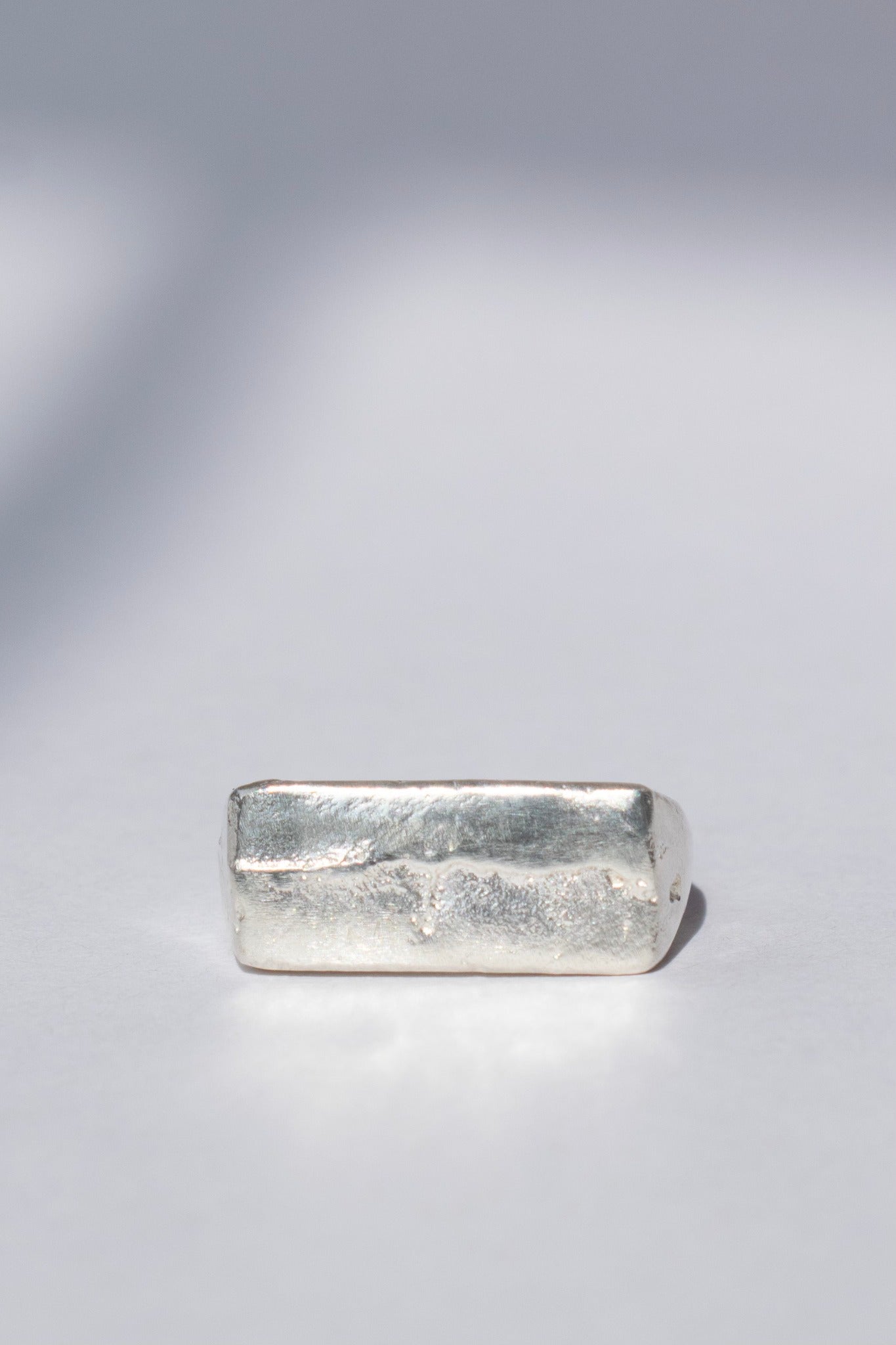 organic silver signet ring on a white background