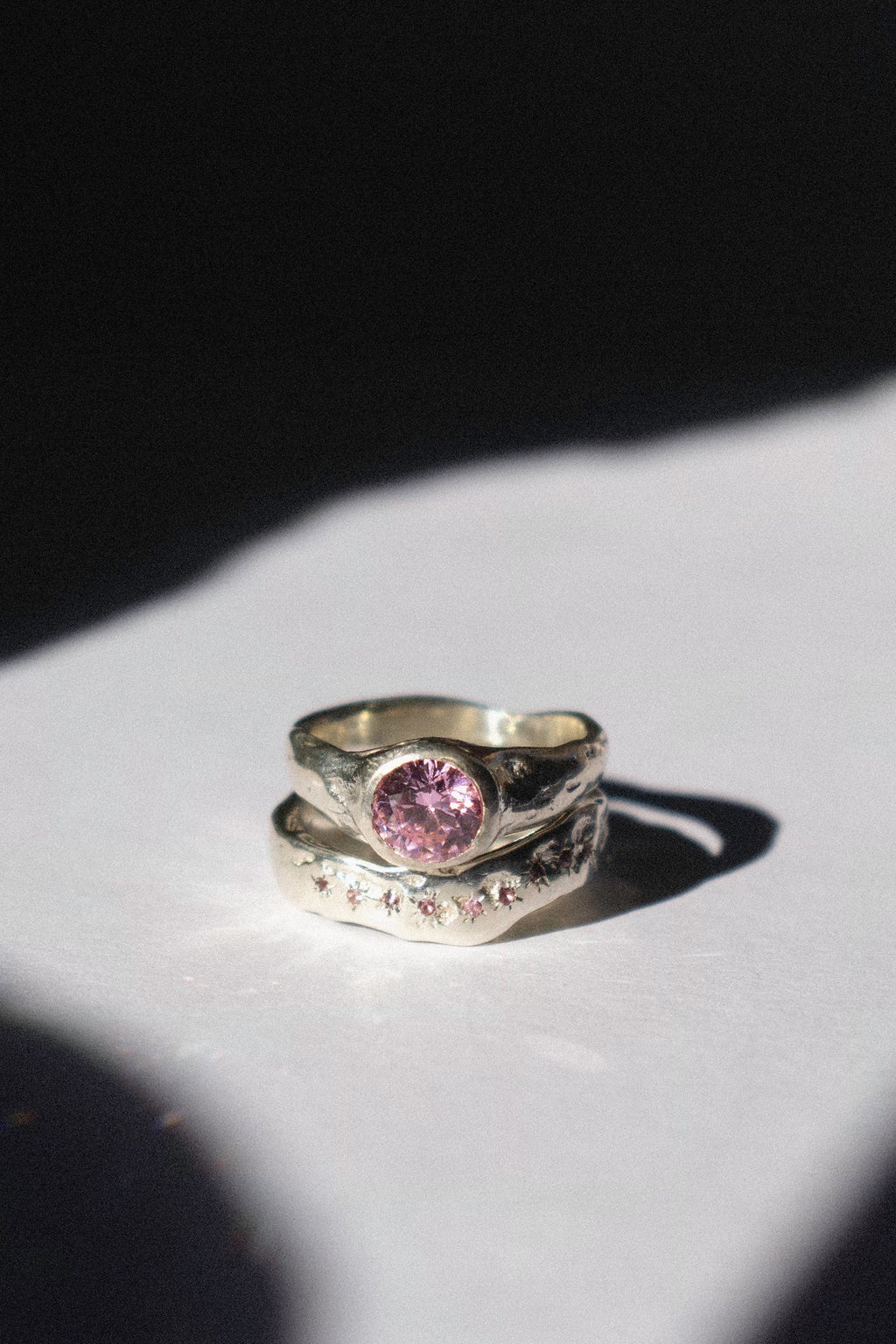 silver and pink cubic zirconia ceremonial ring set on a white background 