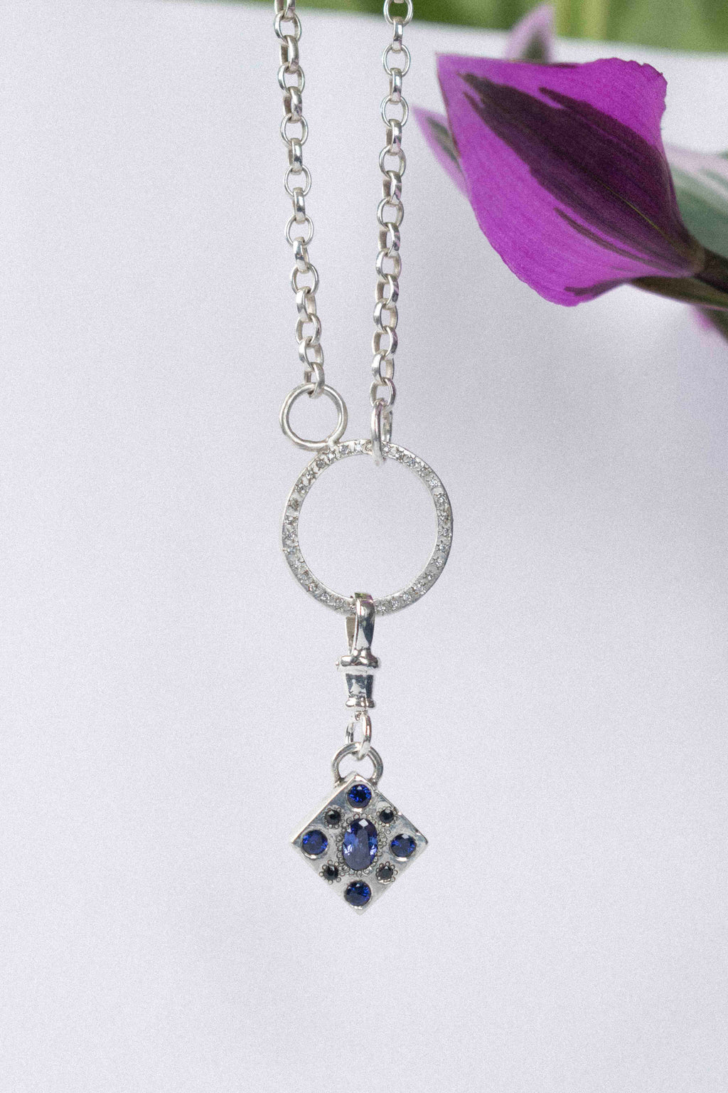 a classic silver chain necklace on a white background