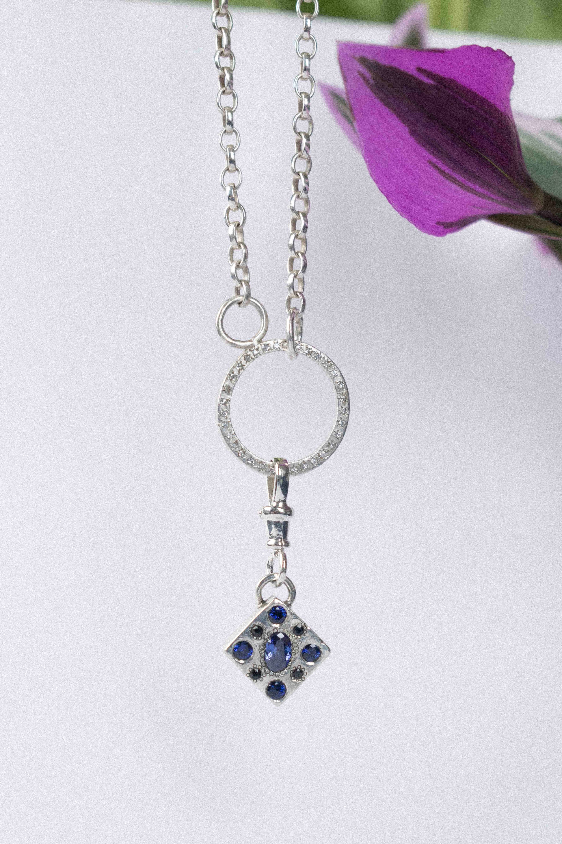 a classic silver chain necklace on a white background