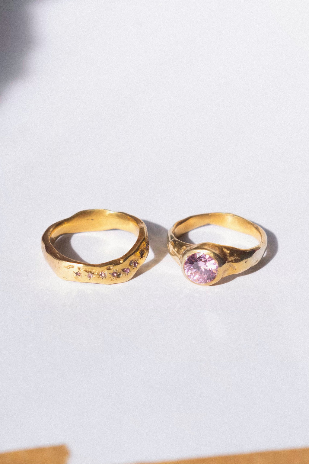 gold and pink diamond ceremonial ring set on a white background