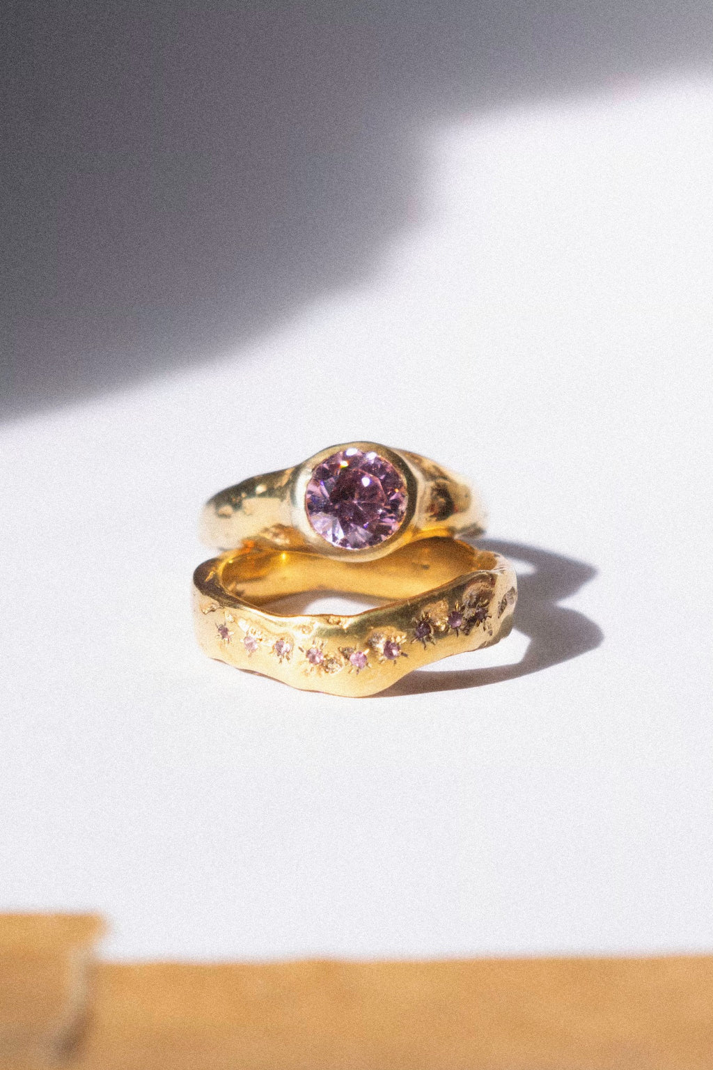 gold and pink diamond ceremonial ring set on a white background